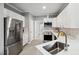 Bright kitchen features stainless steel appliances, white cabinets, and marble backsplash at 6 Danesfield Ct, Durham, NC 27707