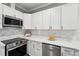 Modern kitchen features stainless steel appliances, marble backsplash, and ample counter space at 6 Danesfield Ct, Durham, NC 27707