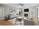 Cozy living room with a fireplace, plush seating, hardwood floors, and a ceiling fan at 6 Danesfield Ct, Durham, NC 27707