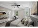 Calm main bedroom with ceiling fan, private balcony, and ensuite bathroom at 6 Danesfield Ct, Durham, NC 27707