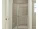 Modern tiled walk-in shower with frameless glass doors and built-in bench at 604 Vega Bluff Ln, Angier, NC 27501