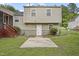 Neutral siding on this multi-story home has a door to the grassy back yard and screened porch at 6927 Beaverwood Dr Dr, Raleigh, NC 27616