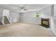 Finished basement offers a cozy fireplace, carpeted floor and staircase, and natural light at 6927 Beaverwood Dr Dr, Raleigh, NC 27616