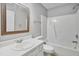 Traditional bathroom featuring a white vanity, wood mirror, and a shower-tub combo at 6927 Beaverwood Dr Dr, Raleigh, NC 27616