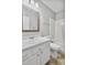 Traditional bathroom featuring a white vanity, wood mirror, and a shower-tub combo at 6927 Beaverwood Dr Dr, Raleigh, NC 27616