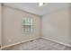 Comfortable bedroom with a light fixture, window, carpeted floors, and neutral paint at 6927 Beaverwood Dr Dr, Raleigh, NC 27616