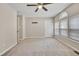 Spacious bedroom with neutral carpeting, ceiling fan, and plenty of natural light from the large windows at 6927 Beaverwood Dr Dr, Raleigh, NC 27616