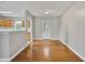 Bright dining room with hardwood floors, neutral paint, and a view of the kitchen at 6927 Beaverwood Dr Dr, Raleigh, NC 27616
