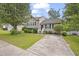 Charming two-story home with a well-maintained front yard and a concrete driveway at 6927 Beaverwood Dr Dr, Raleigh, NC 27616