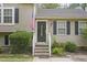 Close-up of the front door, featuring a black door, stairs, and an American flag at 6927 Beaverwood Dr Dr, Raleigh, NC 27616
