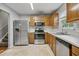 Well-lit kitchen featuring modern stainless steel appliances and ample cabinet space at 6927 Beaverwood Dr Dr, Raleigh, NC 27616