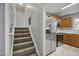 Hallway and stairway that leads to a kitchen with stainless steel appliances at 6927 Beaverwood Dr Dr, Raleigh, NC 27616