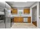 Bright kitchen features stainless steel appliances, wooden cabinets, and a window over the sink at 6927 Beaverwood Dr Dr, Raleigh, NC 27616