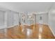 Spacious living room with hardwood floors offers ample natural light and access to the kitchen and stairs at 6927 Beaverwood Dr Dr, Raleigh, NC 27616