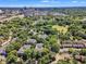Scenic aerial view features the property, mature trees, and city skyline in the distance at 700 Bishops Park Dr # 302, Raleigh, NC 27605