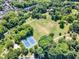 Birds eye view of a green field with tennis courts and lush greenery at 700 Bishops Park Dr # 302, Raleigh, NC 27605