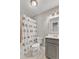 Cozy bathroom featuring a shower with playful bird-themed curtain, white toilet, and gray vanity with sink at 700 Bishops Park Dr # 302, Raleigh, NC 27605