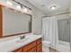 Bathroom features a vanity sink with a large mirror and tub with shower at 700 Bishops Park Dr # 302, Raleigh, NC 27605