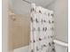 Bright bathroom with a unique bird-themed shower curtain and neutral-toned tiles at 700 Bishops Park Dr # 302, Raleigh, NC 27605