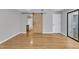 Bedroom featuring hardwood floors, a sliding barn door to bathroom, and a sliding door to the exterior at 700 Bishops Park Dr # 302, Raleigh, NC 27605