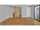 Spacious bedroom featuring hardwood floors, a sliding barn door, and neutral paint at 700 Bishops Park Dr # 302, Raleigh, NC 27605