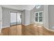 Cozy bedroom with hardwood floors, a sliding door to a balcony, and a view-framing window at 700 Bishops Park Dr # 302, Raleigh, NC 27605