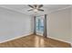 Bedroom with hardwood floors, neutral colors, and a large window with natural light at 700 Bishops Park Dr # 302, Raleigh, NC 27605