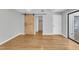 Bright bedroom features hardwood floors and natural light from a sliding glass door at 700 Bishops Park Dr # 302, Raleigh, NC 27605