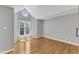 Bedroom with hardwood floors, natural light, and a vaulted ceiling with round window at 700 Bishops Park Dr # 302, Raleigh, NC 27605