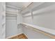 Walk-in closet featuring multiple levels of shelving and wooden rods at 700 Bishops Park Dr # 302, Raleigh, NC 27605