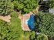 Aerial view of the community pool surrounded by trees and lounge chairs at 700 Bishops Park Dr # 302, Raleigh, NC 27605