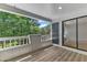 Outdoor deck with beautiful wooded views and glass sliding door access at 700 Bishops Park Dr # 302, Raleigh, NC 27605