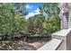 Exterior view featuring mature trees, beautiful landscaping, and elegant brickwork at 700 Bishops Park Dr # 302, Raleigh, NC 27605