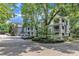 Attractive condo exteriors with brick paved driveways and balconies, complemented by mature trees at 700 Bishops Park Dr # 302, Raleigh, NC 27605