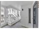 Bright hallway with white railings, outdoor access, and stairs visible from the door at 700 Bishops Park Dr # 302, Raleigh, NC 27605