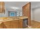 Open kitchen with wood cabinets, stainless steel appliances, granite countertops, and exposed brickwork at 700 Bishops Park Dr # 302, Raleigh, NC 27605