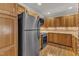 Well-lit kitchen with stainless steel appliances, oak cabinets, and a brick backsplash at 700 Bishops Park Dr # 302, Raleigh, NC 27605