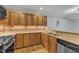 Traditional kitchen features wood cabinets, stainless steel appliances, brick backsplash, and granite countertops at 700 Bishops Park Dr # 302, Raleigh, NC 27605