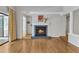 Bright living room with hardwood floors, a fireplace and access to a balcony with green views at 700 Bishops Park Dr # 302, Raleigh, NC 27605
