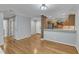 Bright open-concept living area with hardwood floors, flowing into kitchen; great layout at 700 Bishops Park Dr # 302, Raleigh, NC 27605
