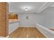 Open living room featuring hardwood floors and seamless transition into a kitchen at 700 Bishops Park Dr # 302, Raleigh, NC 27605