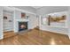 An open living area features hardwood floors, a fireplace, and a partial wall dividing the kitchen at 700 Bishops Park Dr # 302, Raleigh, NC 27605