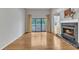 A large, open living area features hardwood floors, a fireplace and access to a patio at 700 Bishops Park Dr # 302, Raleigh, NC 27605