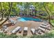 Community pool surrounded by lounge chairs and a lush green landscape, perfect for relaxation and recreation at 700 Bishops Park Dr # 302, Raleigh, NC 27605