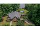 Stunning aerial view of brick home, pool and backyard near a serene lake at 7483 Danford Rd, Burlington, NC 27215