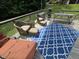 Back deck with cozy seating, picnic table, a grill and an outdoor rug at 7483 Danford Rd, Burlington, NC 27215