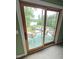 Enjoy the view from this balcony with a trampoline, pool, lake, and luscious trees at 7483 Danford Rd, Burlington, NC 27215