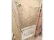 Bathroom featuring tile walls, shower head, and a bathtub at 7483 Danford Rd, Burlington, NC 27215