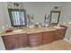 Spacious bathroom featuring double vanities, granite countertops, and decorative mirrors at 7483 Danford Rd, Burlington, NC 27215