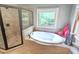 Beautiful bathroom showcasing a soaking tub beneath a window and an adjacent glass enclosed shower at 7483 Danford Rd, Burlington, NC 27215